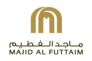Majid Al Futtaim logo: gold stylized emblem above the brand name in Arabic and English.